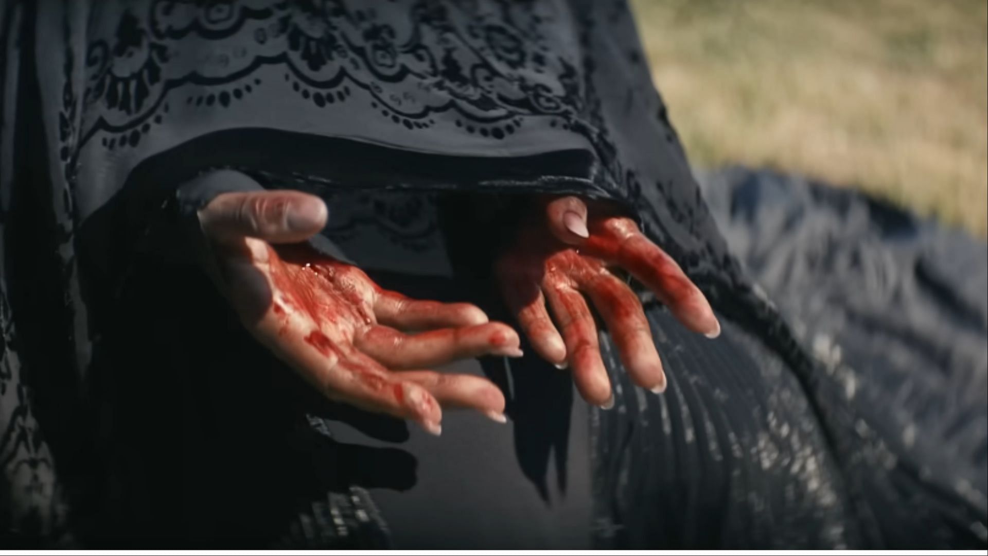 The Woman in the Yard’s blood-stained hands hint at a past soaked in guilt, blurring the line between the supernatural and psychological (Image via Universal Pictures)